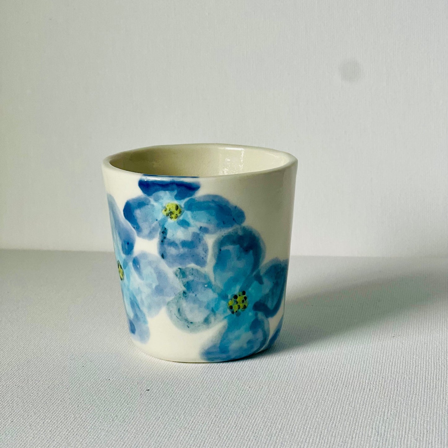 A hand painted porcelain cup - A Cup with a message